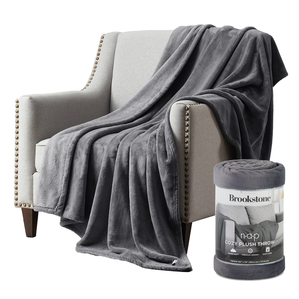 Gray plush throw blanket draped over a chair with its packaging next to it.